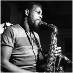 Ornette Coleman, in a T-shirt, plays his saxophone