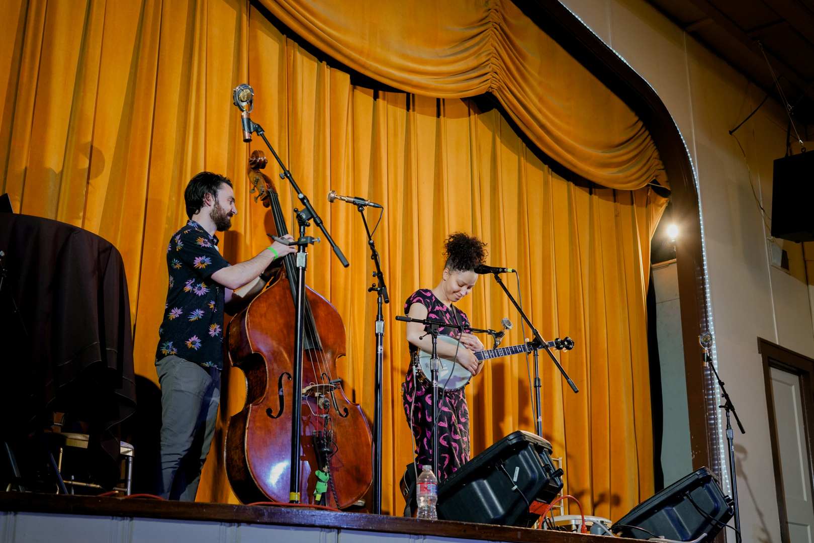 A woman plays banjo and a man plays upright bass