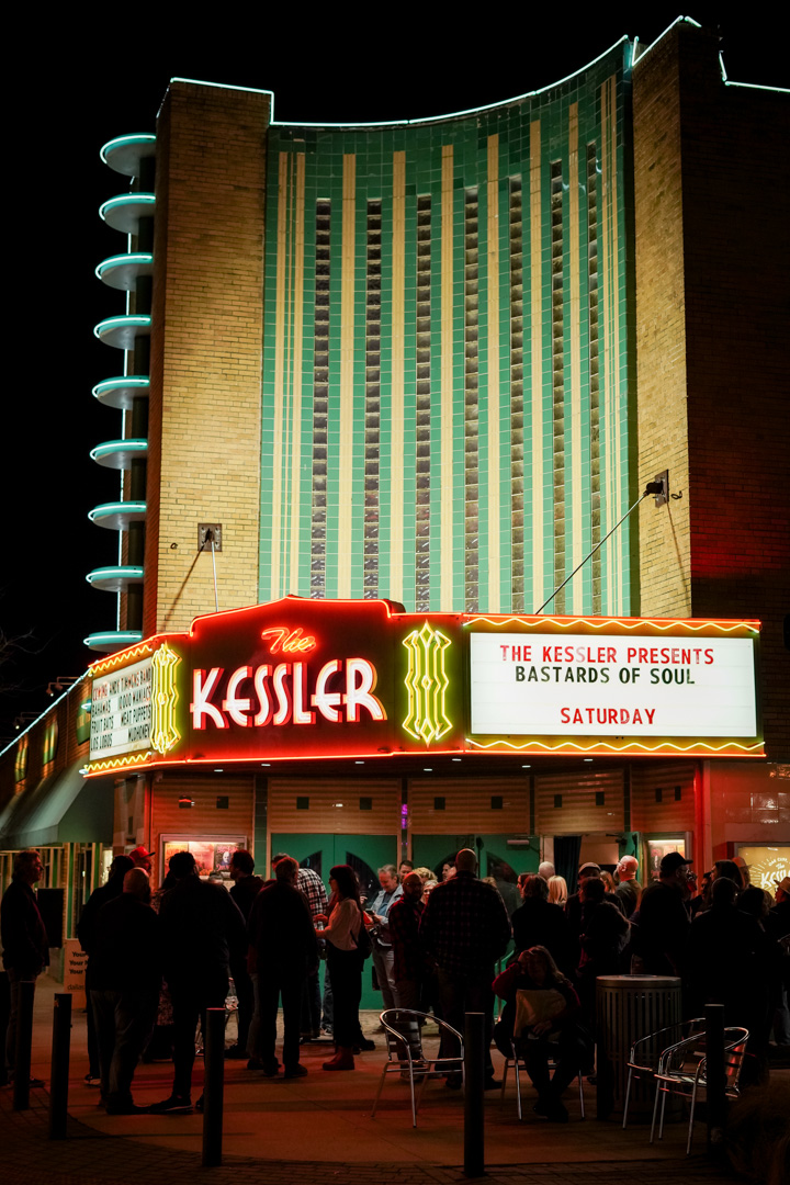 A theater facade at night lit up in lights
