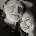 Willie Nelson, wearing a cowboy hat, stands next to his sister, Bobbie Nelson