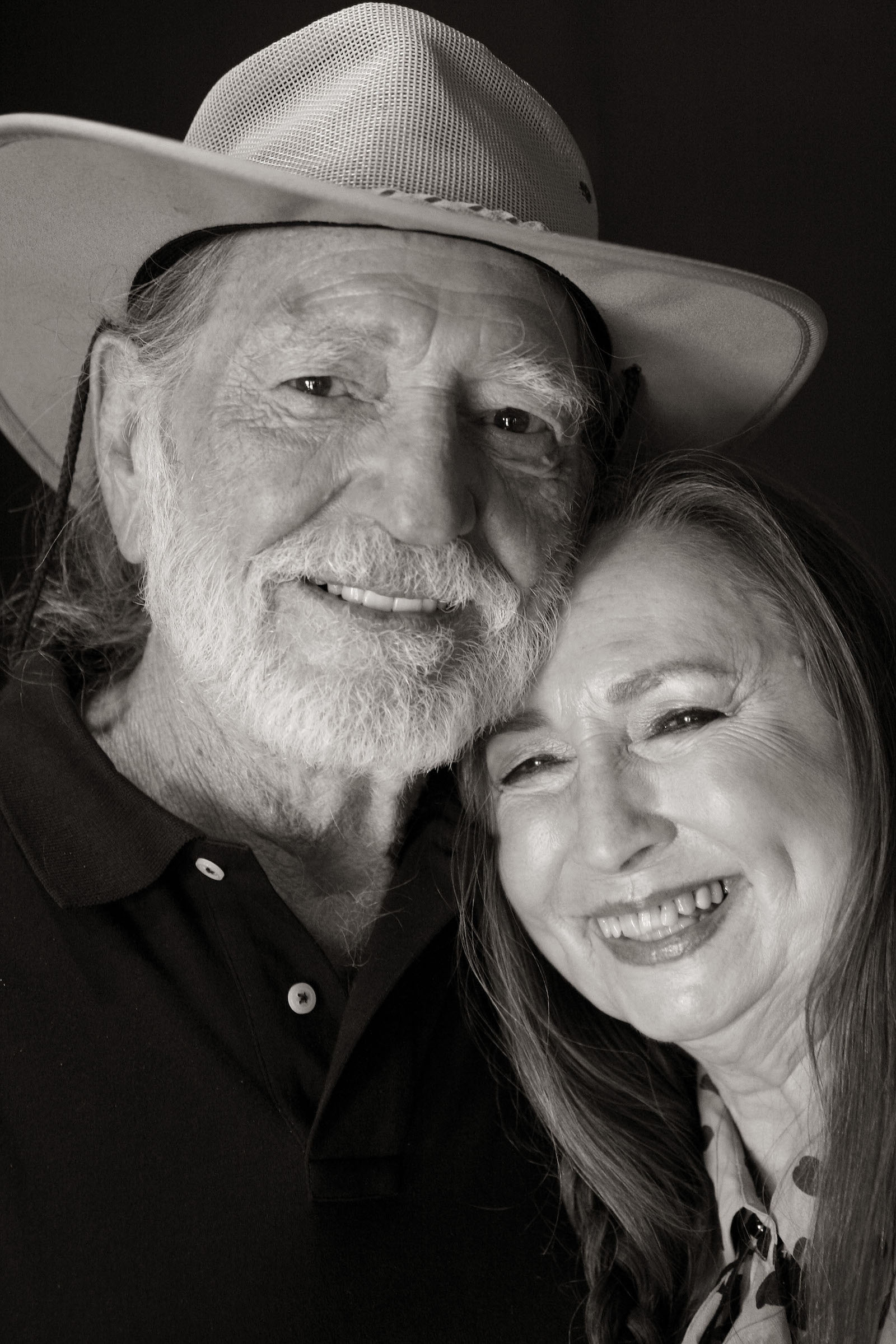 Willie Nelson, wearing a cowboy hat, stands next to his sister, Bobbie Nelson