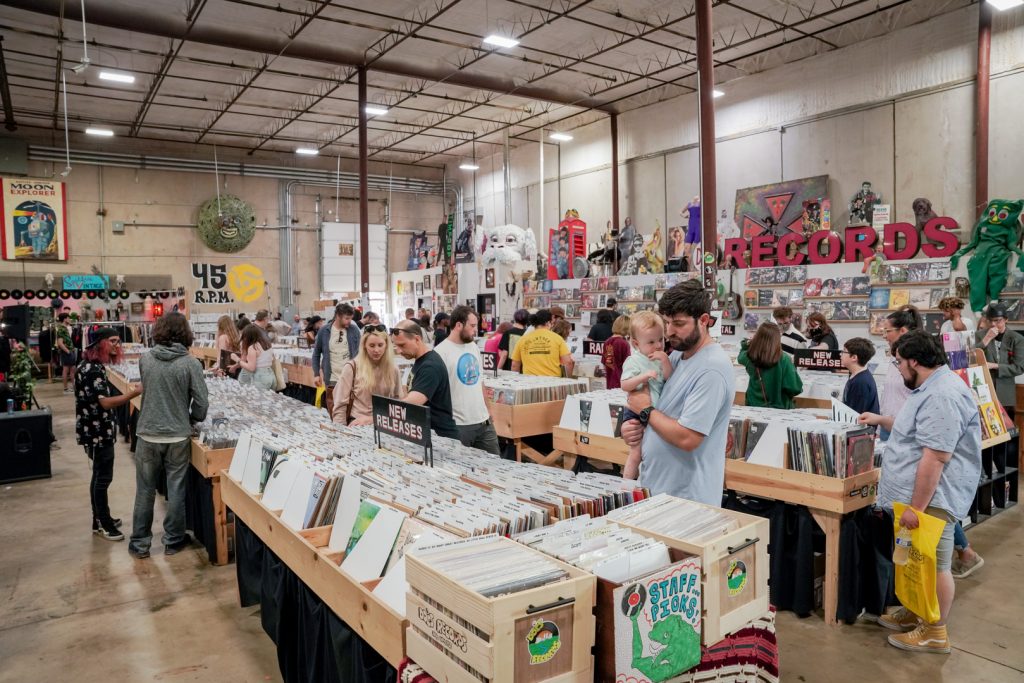 People looking through crates of records in a record store