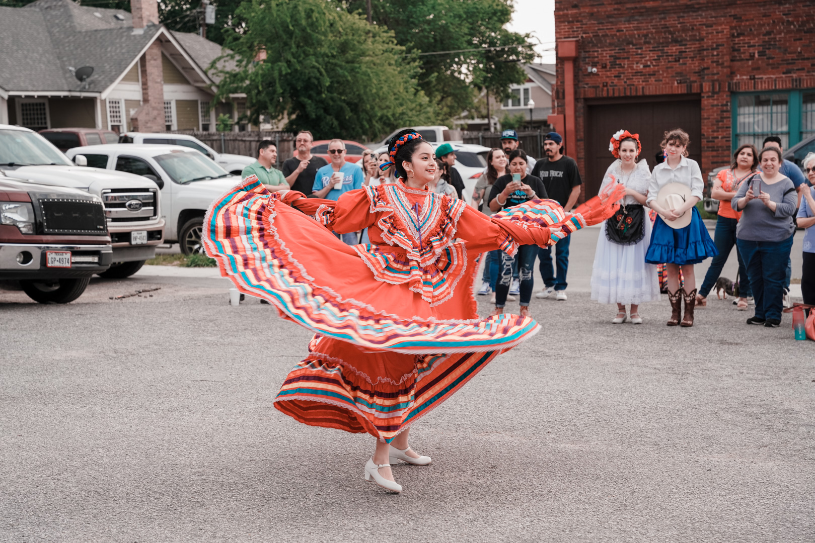 A young woman dances in a traditional Mexican dance dress