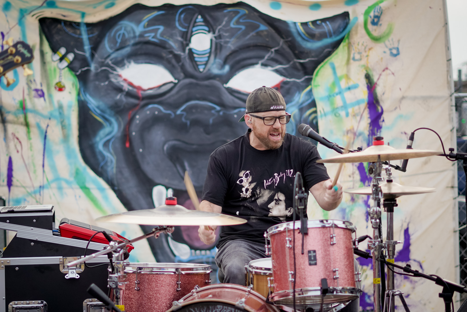 Drummer in front of panther mural