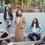 My Morning Jacket is gathered outside, in front of a landscaped area full of cacti