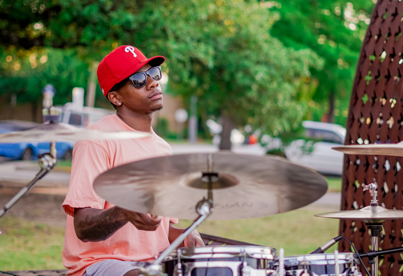 A drummer plays in red hat