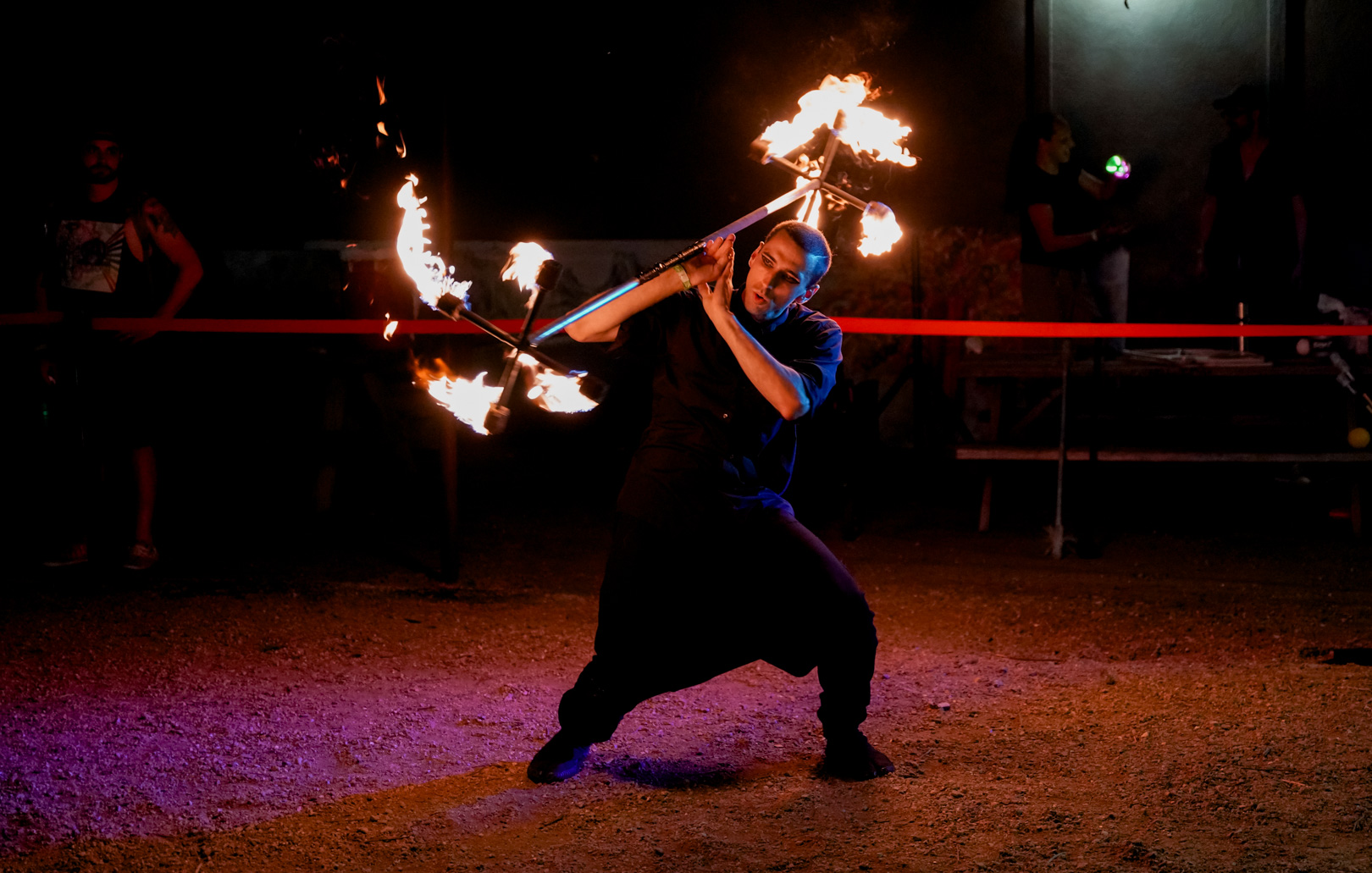 A man fire performing with dragon staff