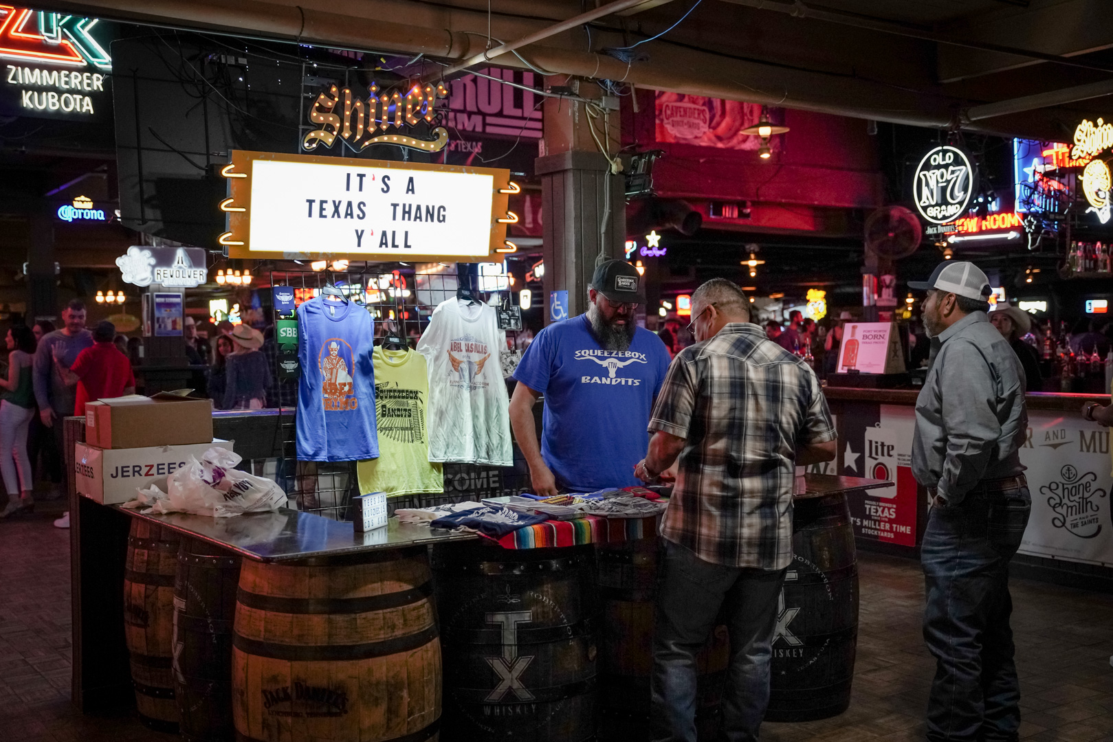 A man sells t-shirts to music fans