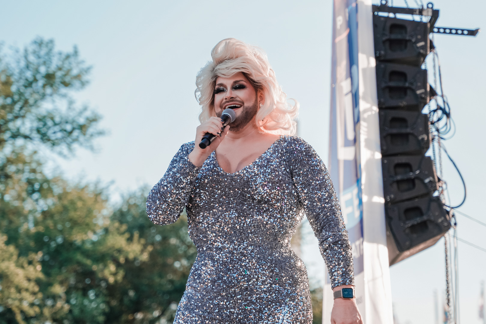A performer on stage in a very sparkly dress