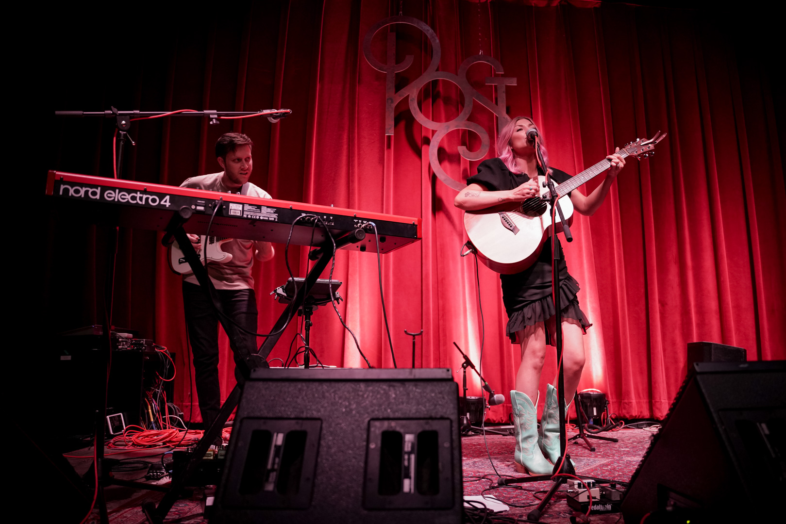 A man and woman play music on stage
