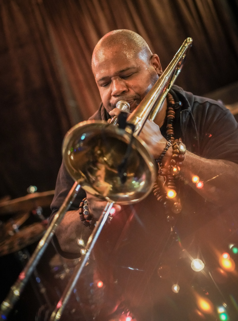 A man plays trombone on stage