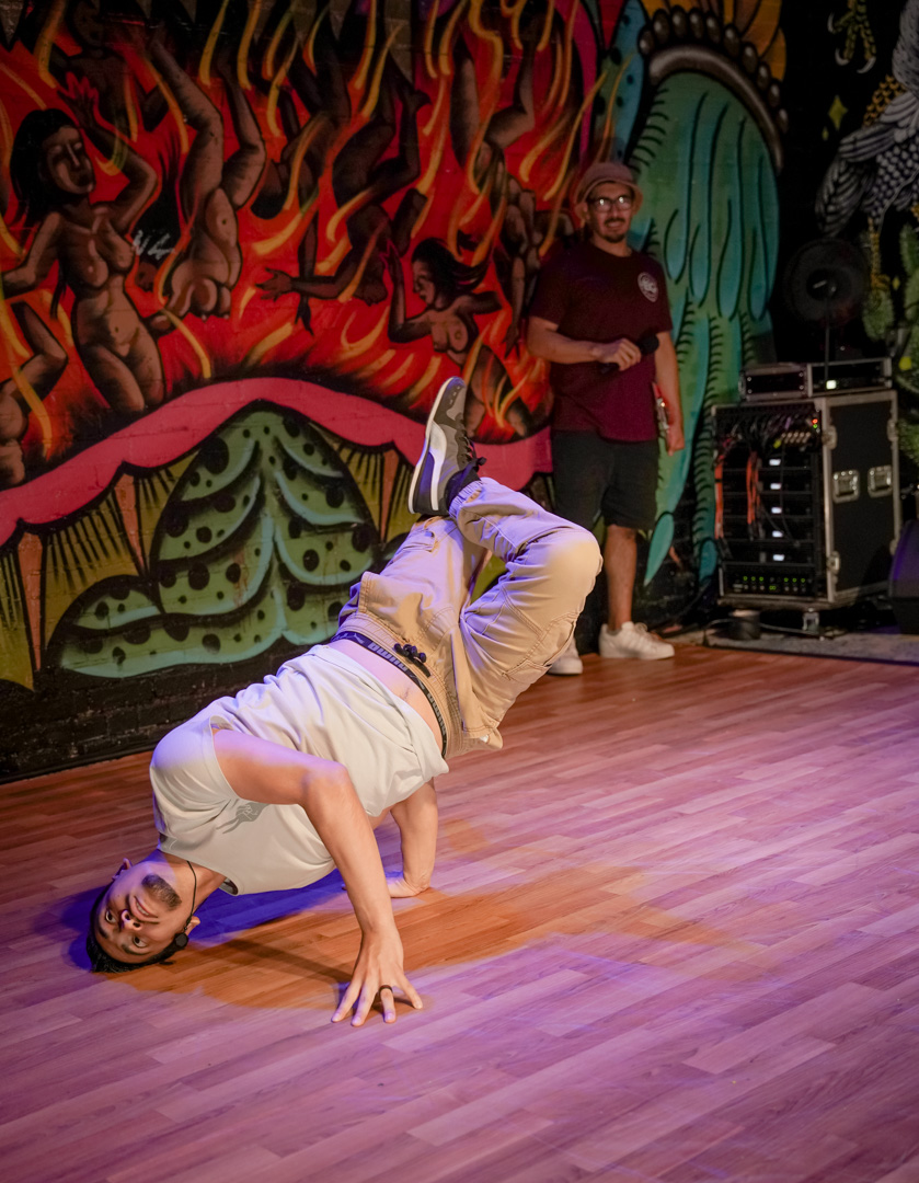 A dancer in a break dance pose on stage