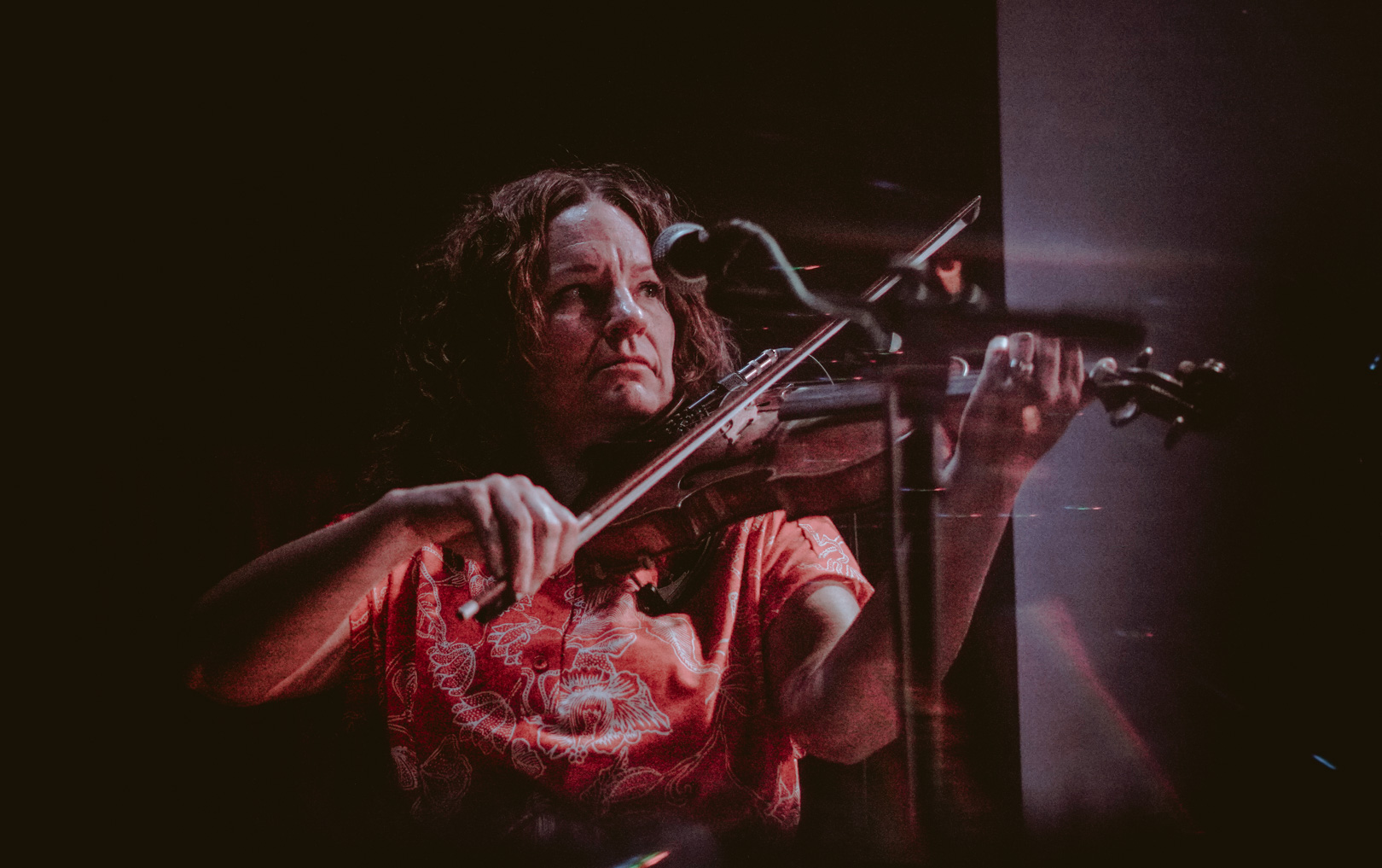 A woman plays violin on stage
