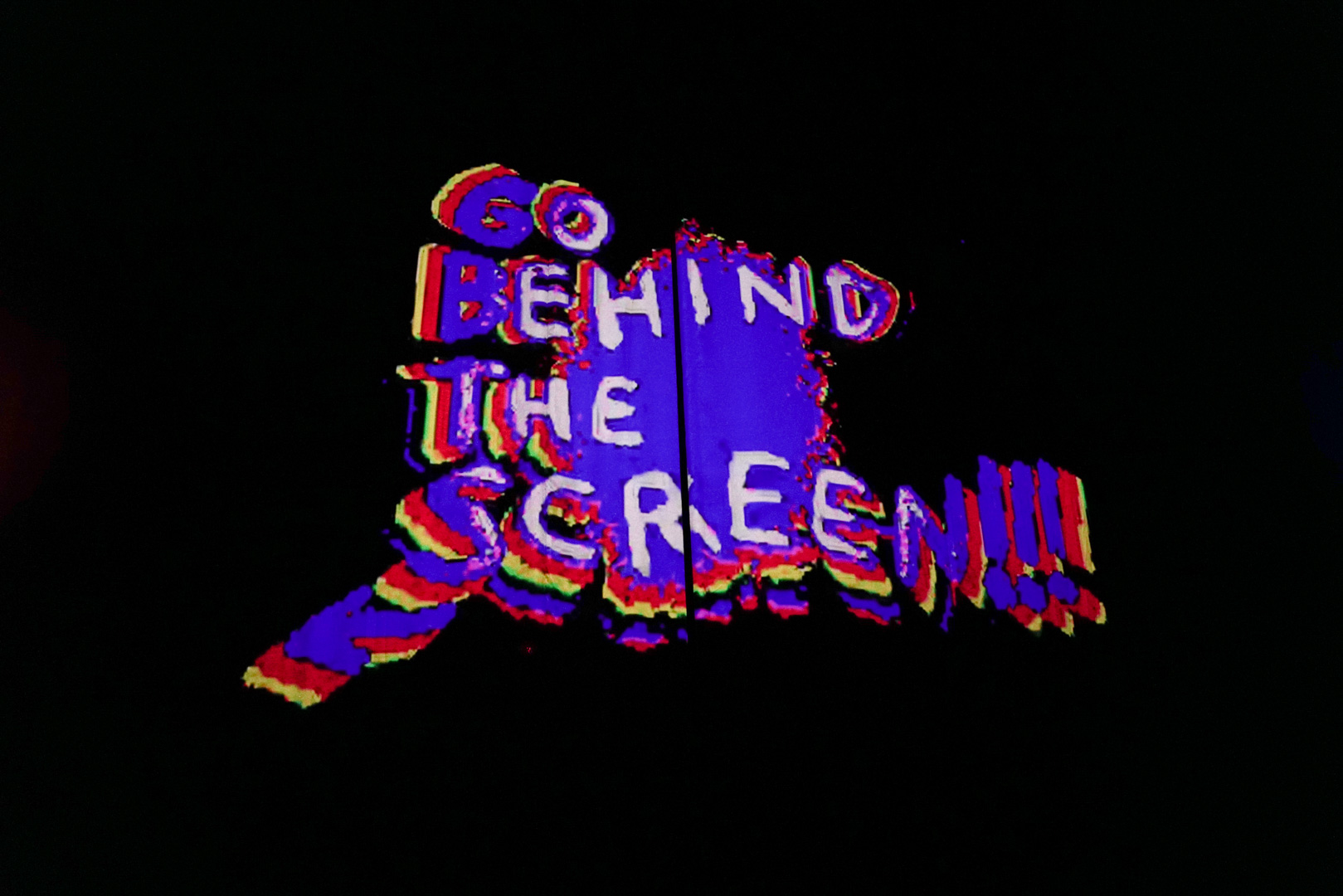A movie screen with "Go Behind the Screen!" projected