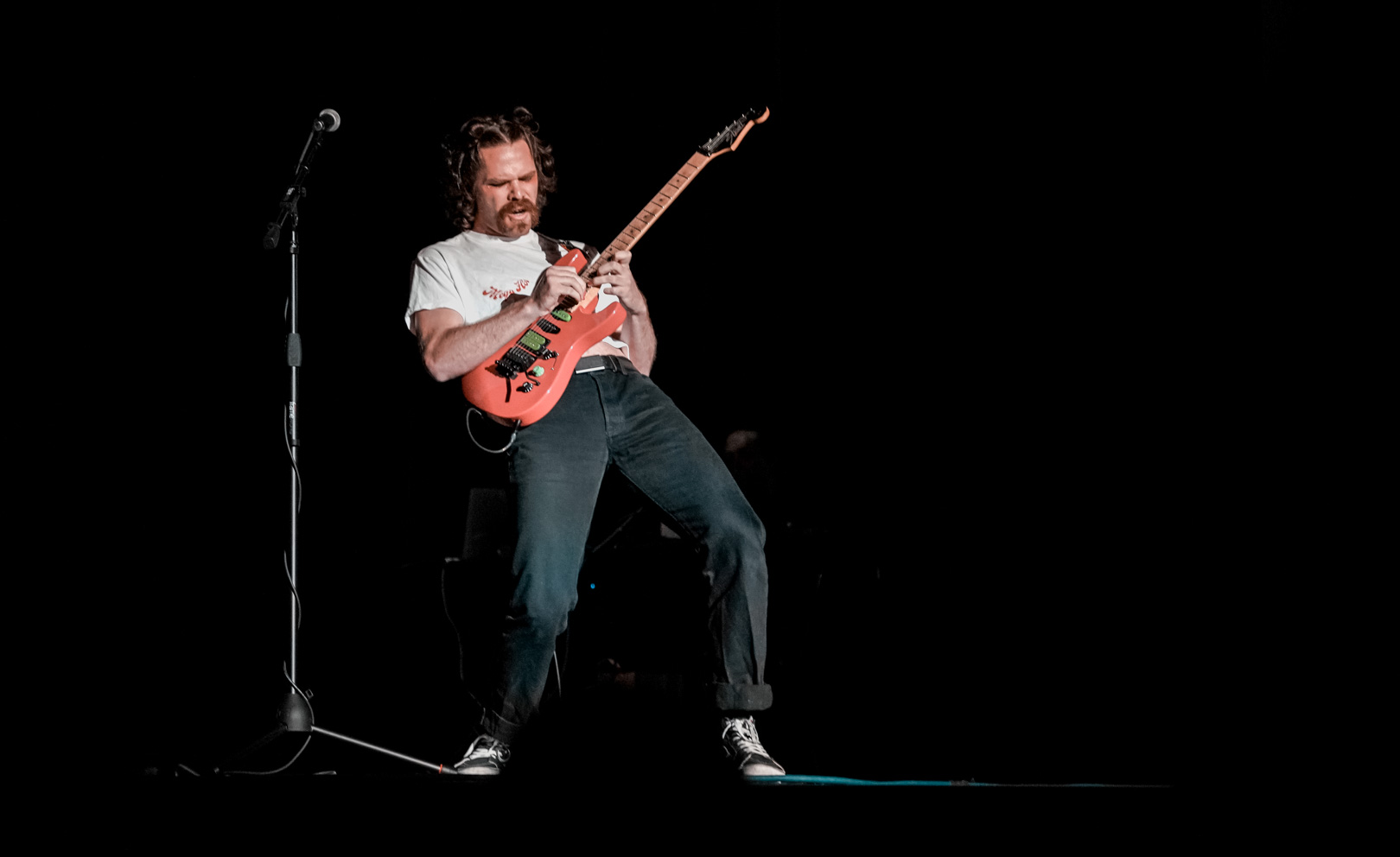 A man plays guitar on stage