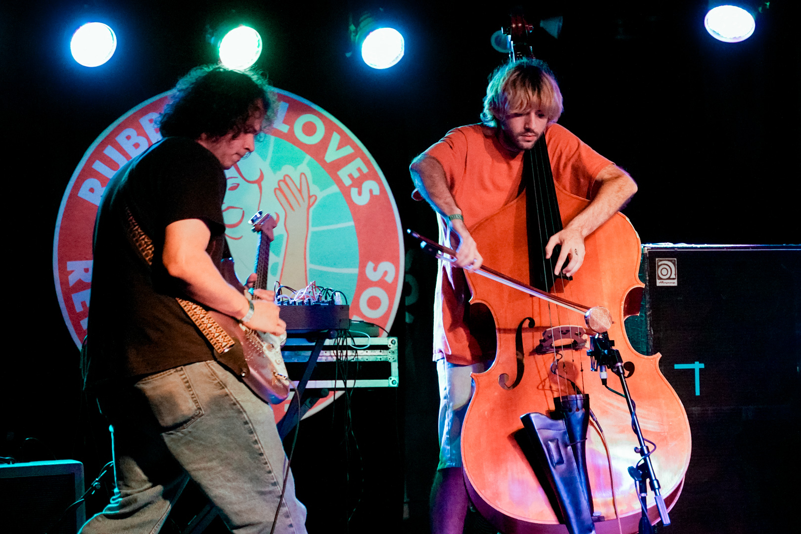 A guitarist and upright bass player on stage