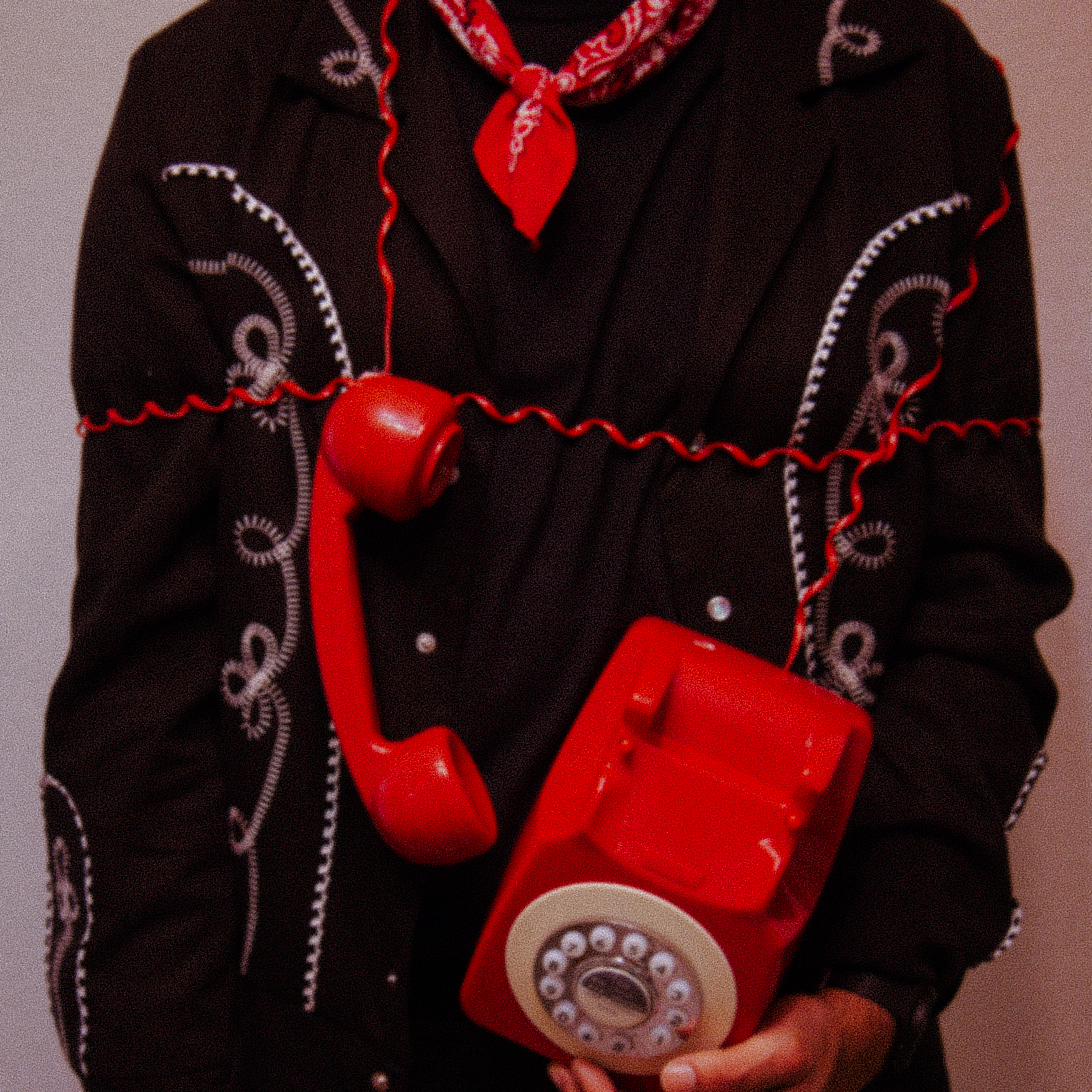 A man's torso wrapped in red telephone cord