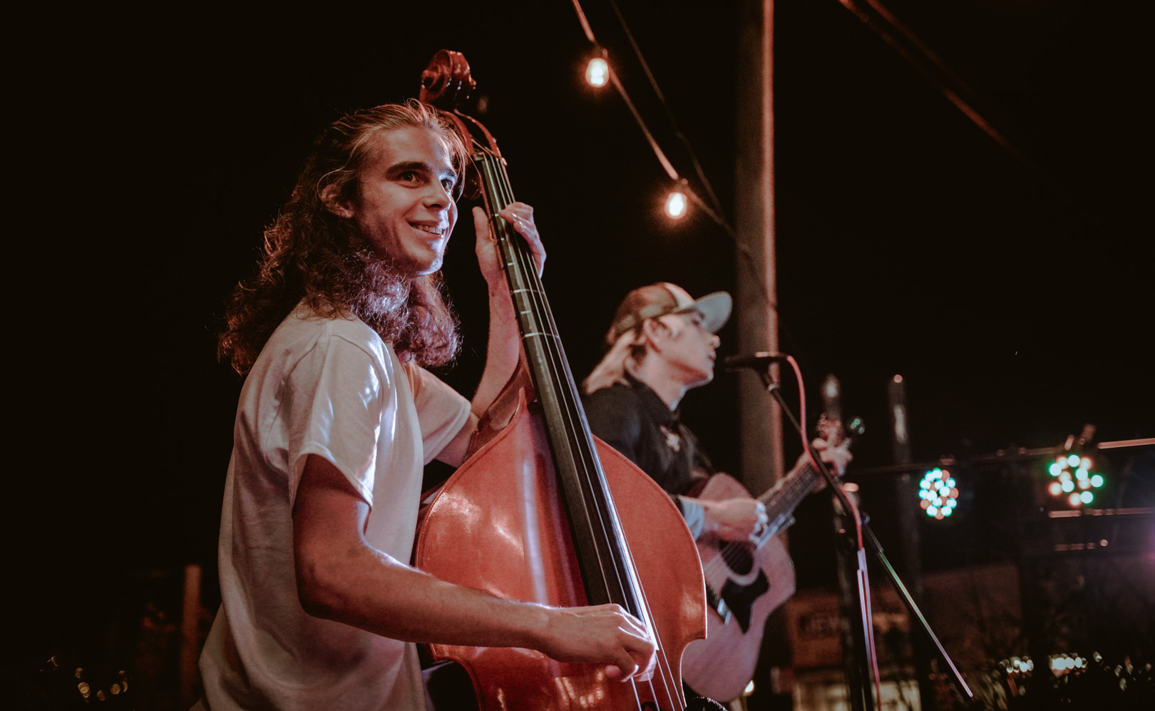 A young man playing upright bass