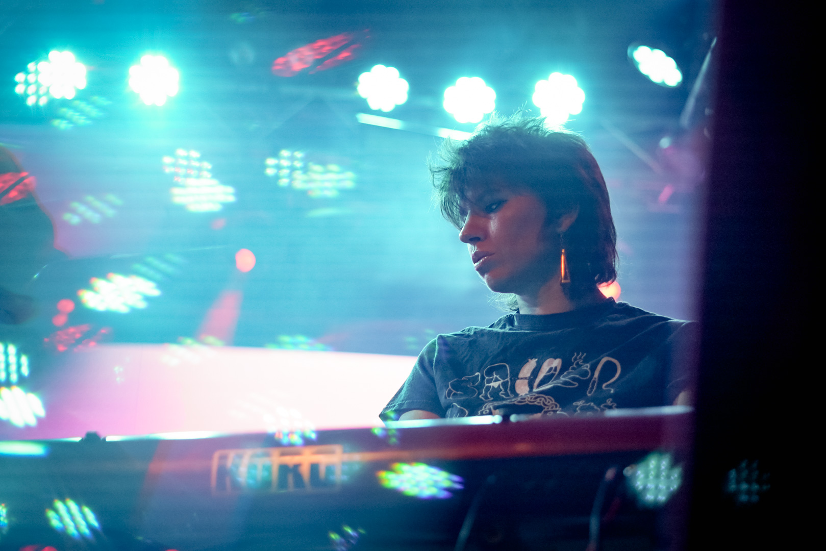 A woman playing keyboard on stage