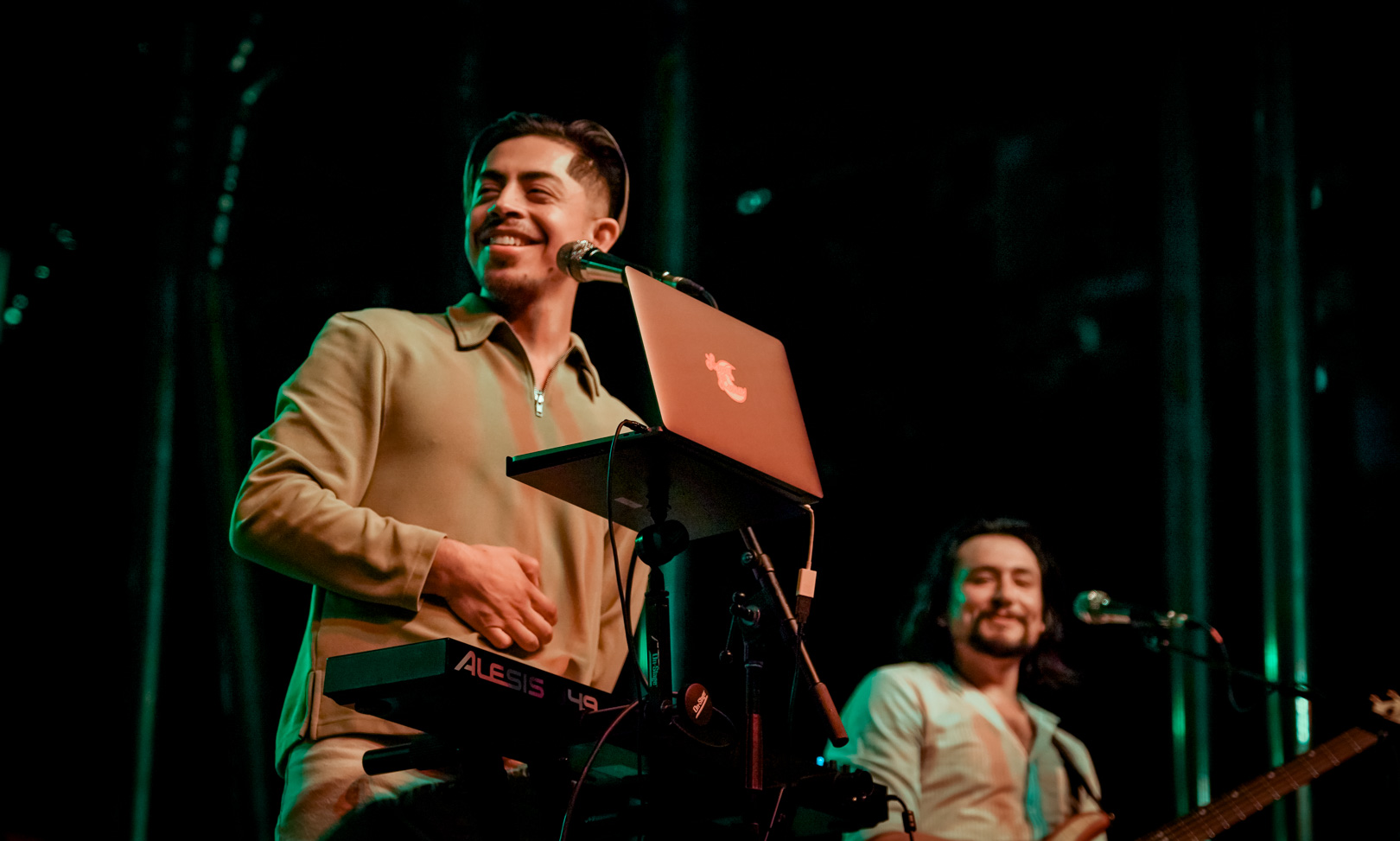 Two performers smiling on stage
