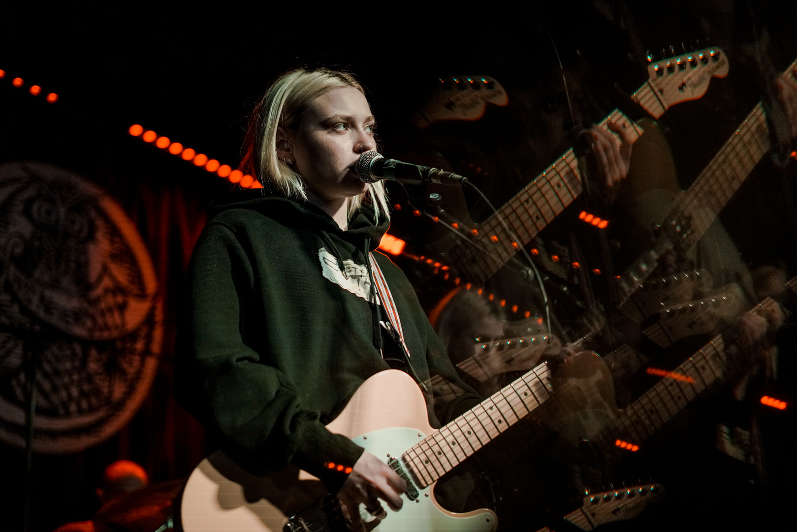 A woman playing guitar on stage