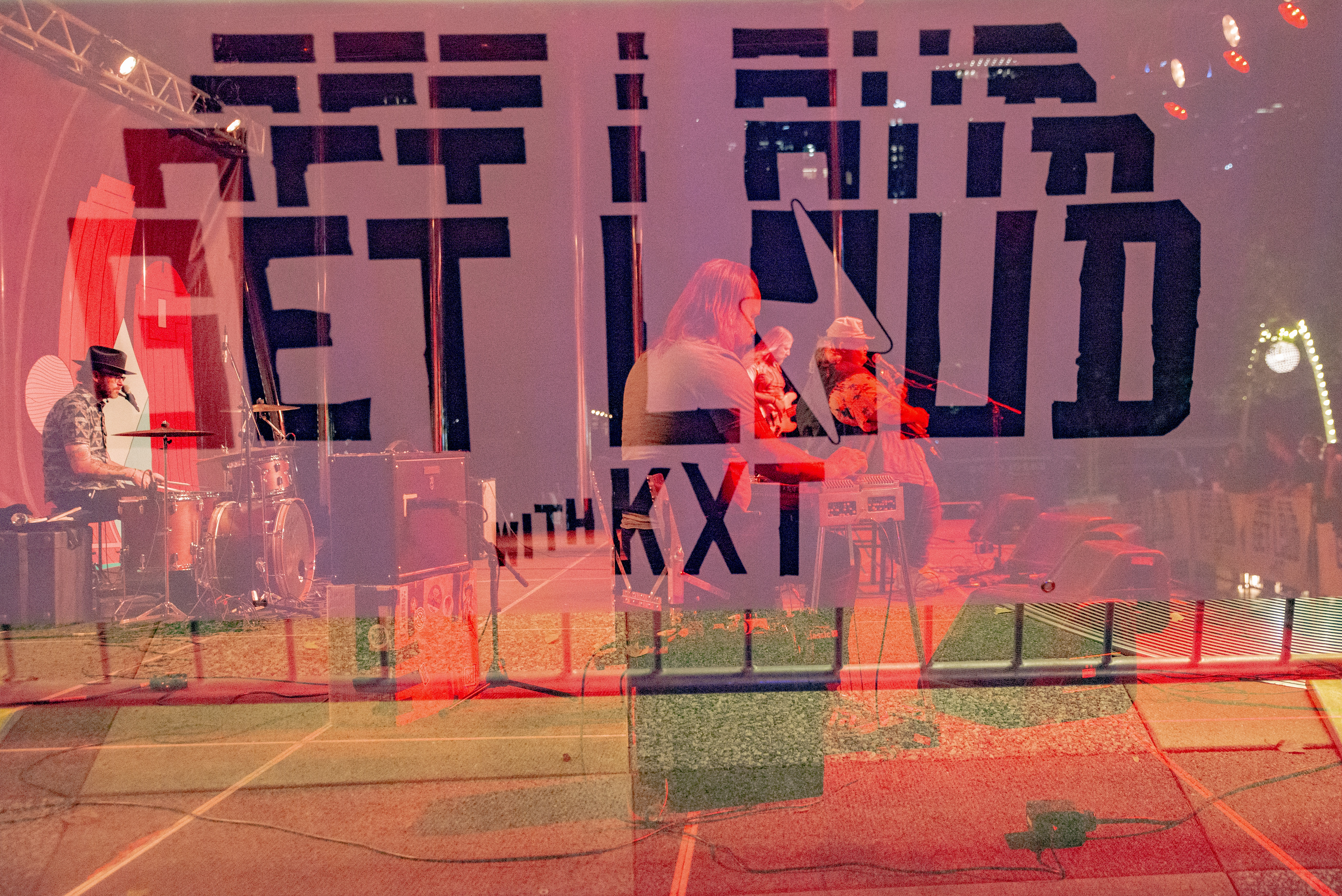 A double exposure image with a band and event banner 