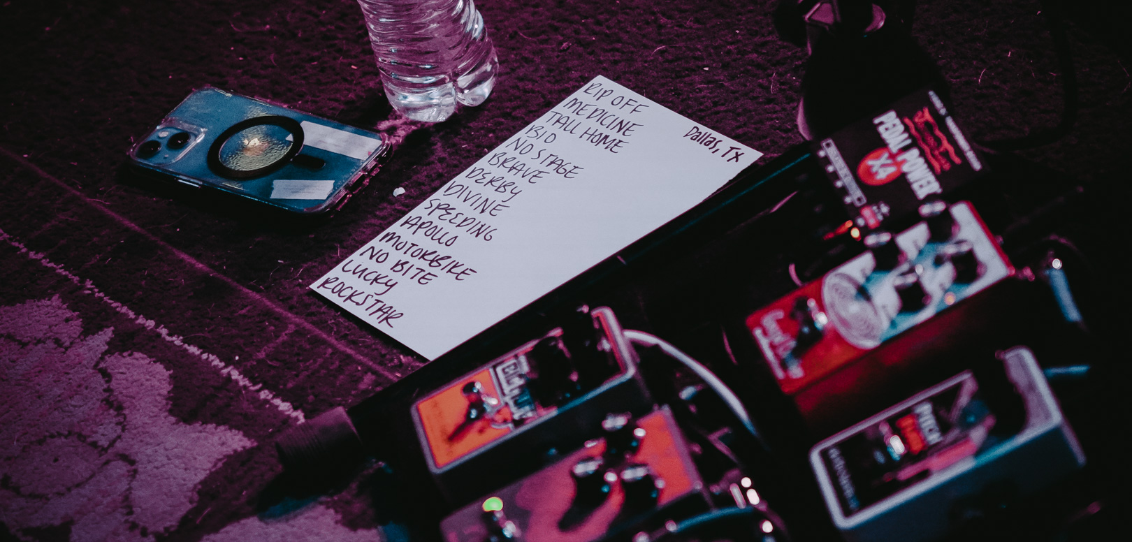 a list of songs on a piece of paper on stage