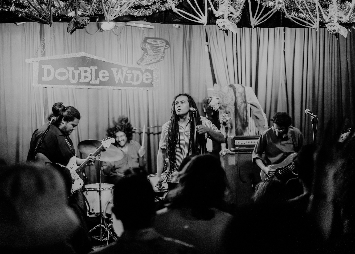 A full band on stage, black and white photo