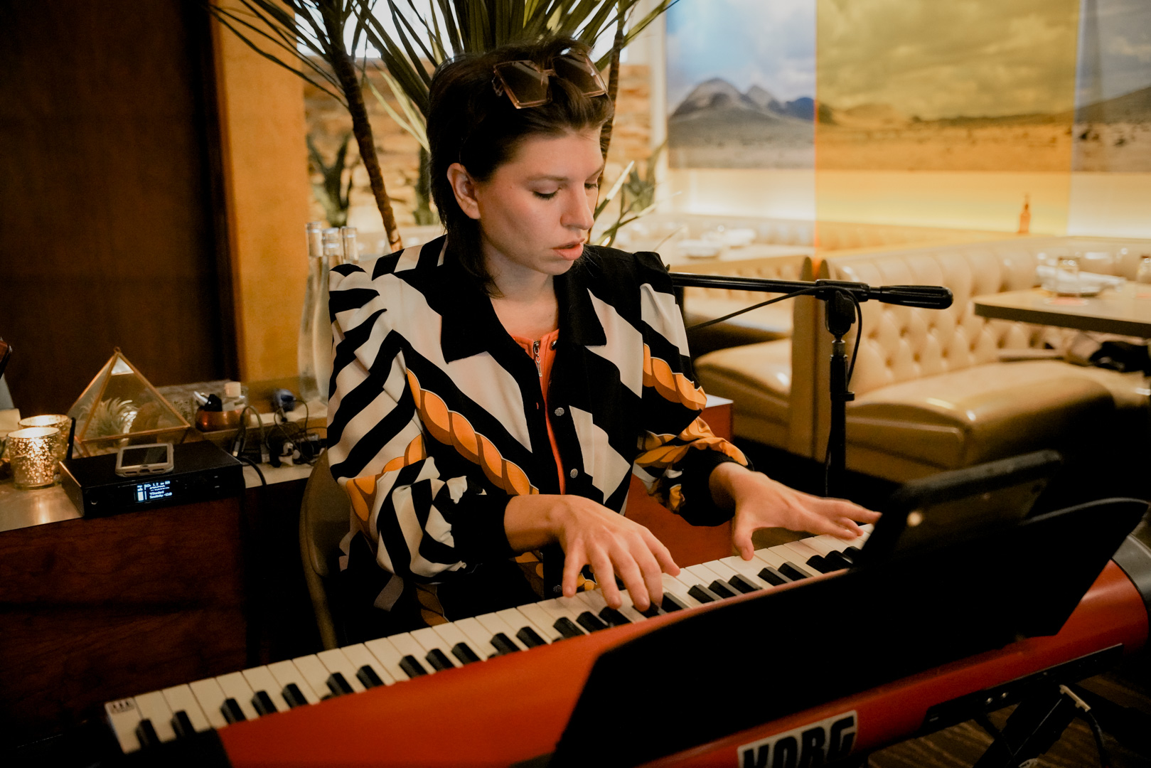 A woman plays keyboard in a lounge