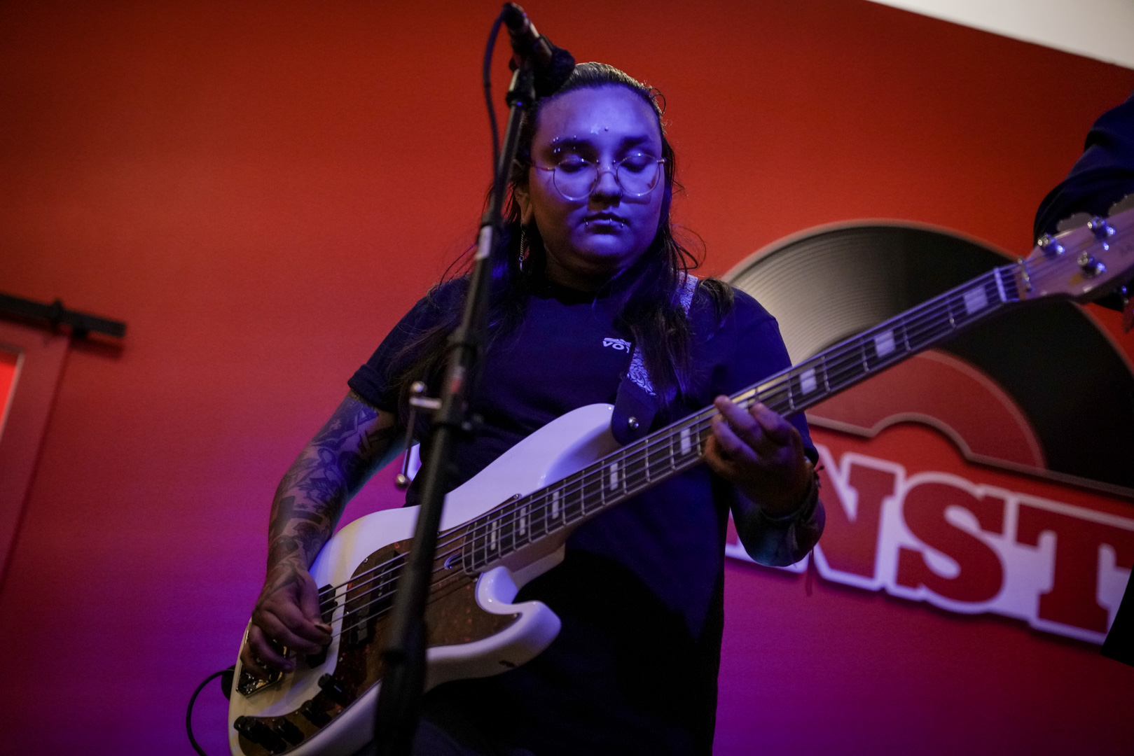 A person playing bass on stage