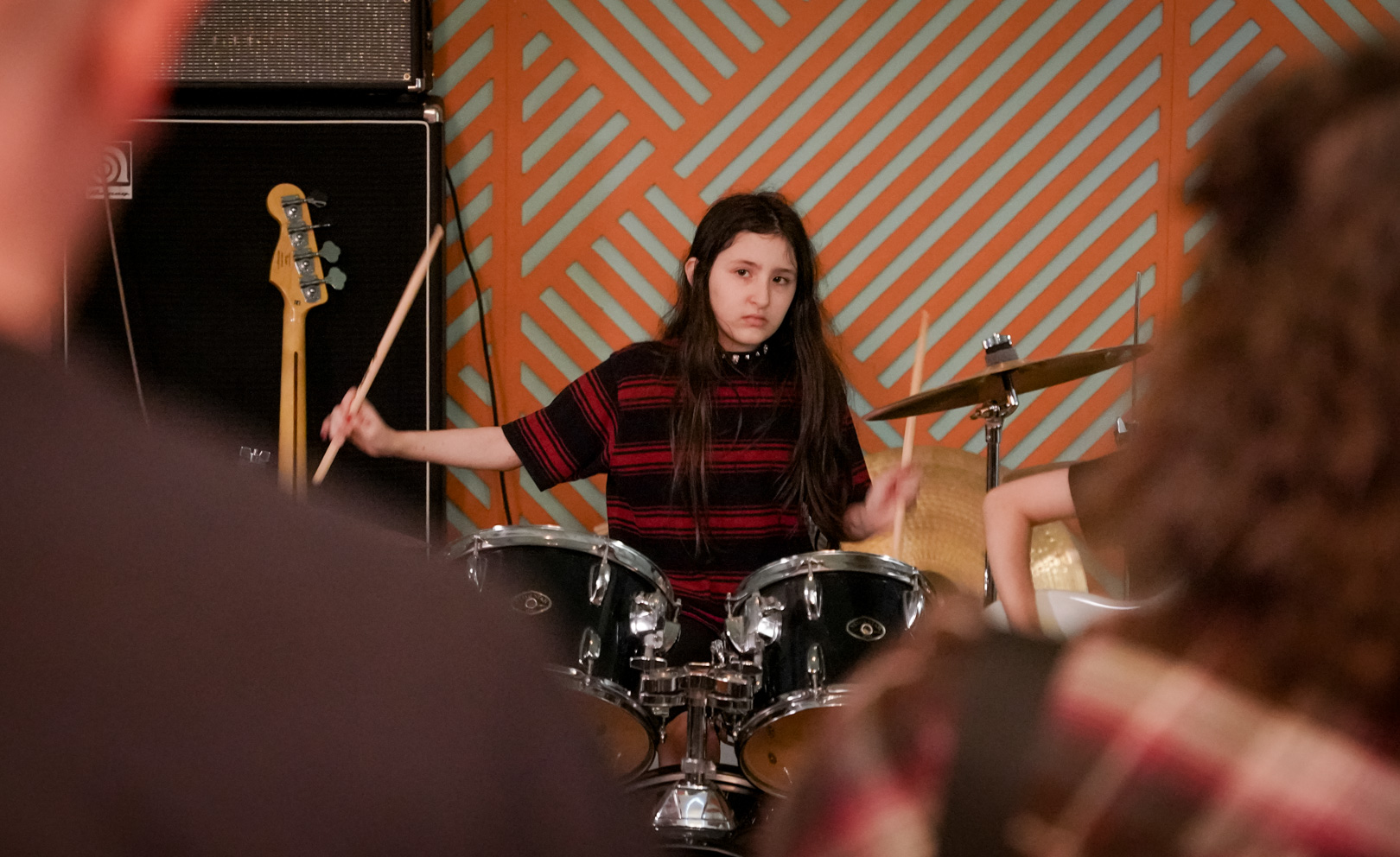 A young girl playing drums