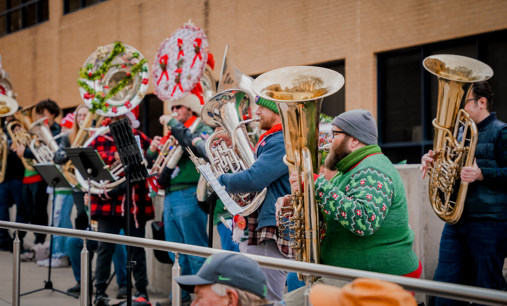 Sousaphone and tuba players with festively decorated instruments