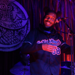 A man smiles on stage