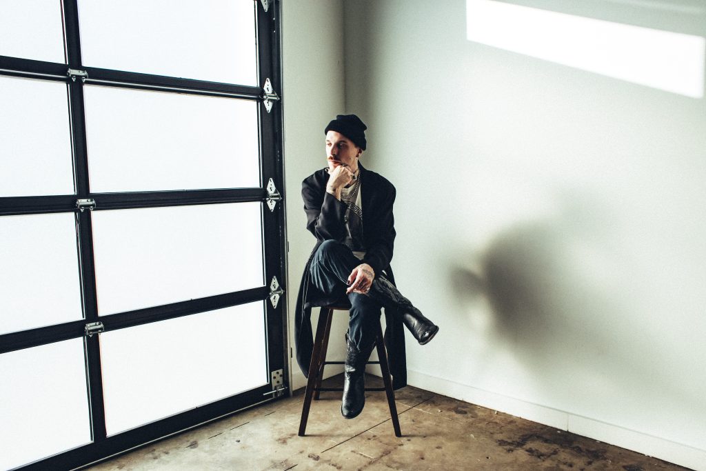 A man sitting on a chair in a white room