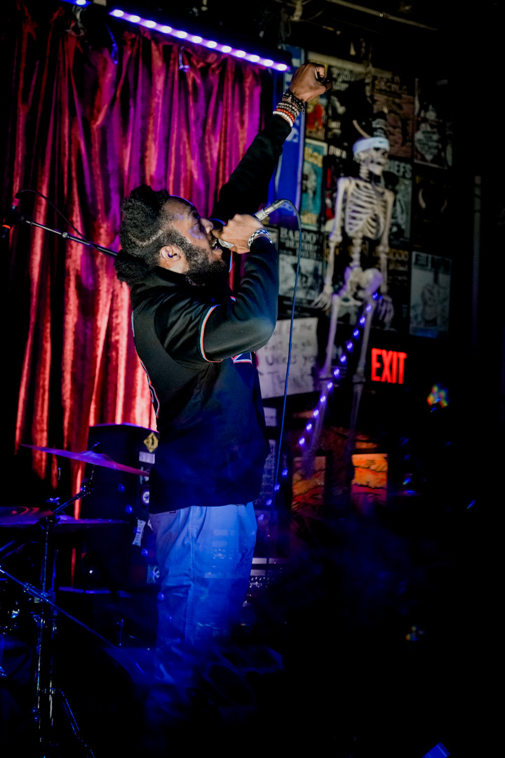 A singer with his fist in the air at Three Links