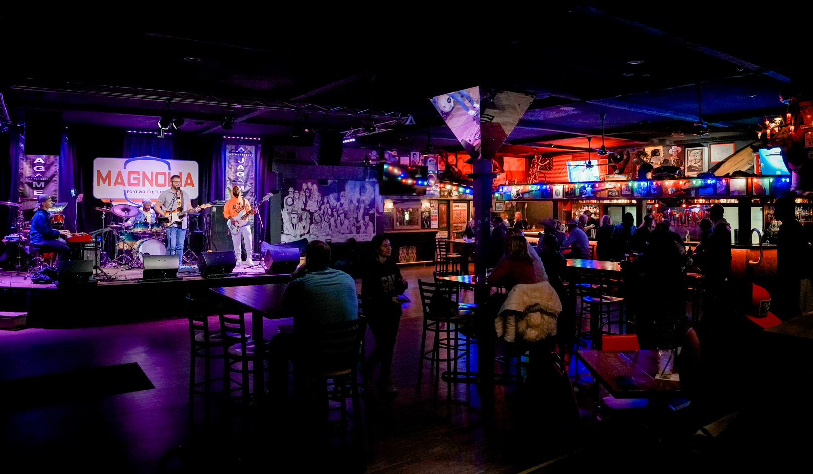A wide shot of the interior of a bar and a stage
