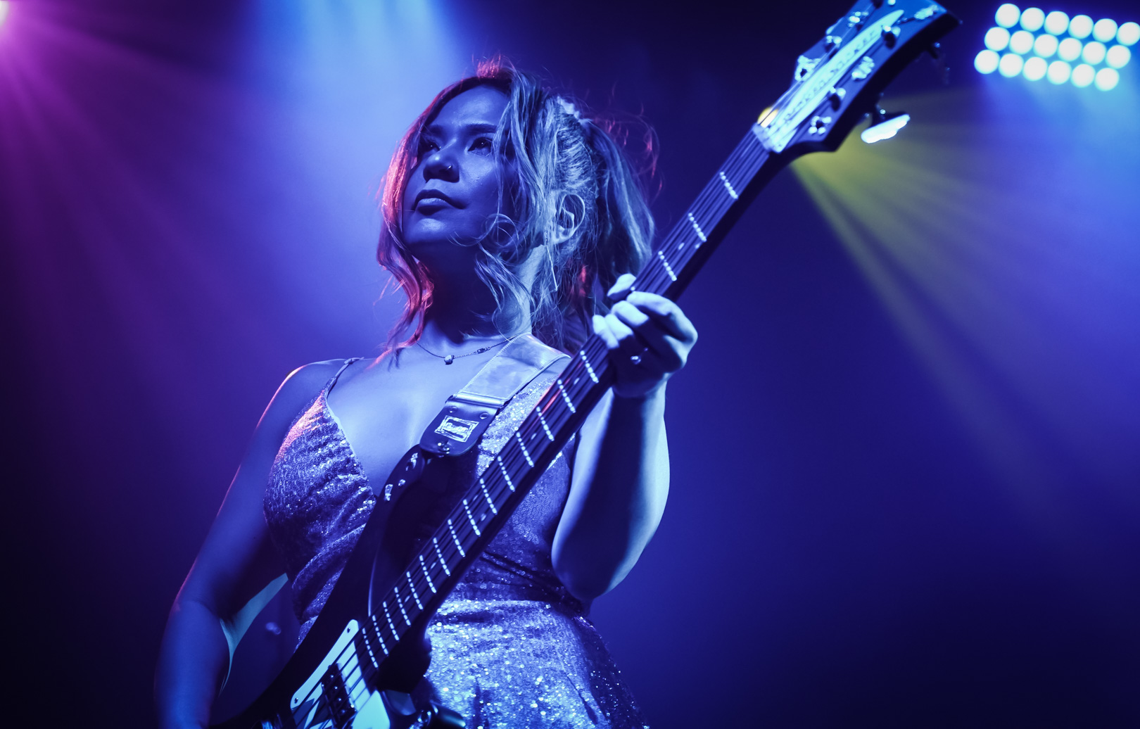 A woman playing bass on stage