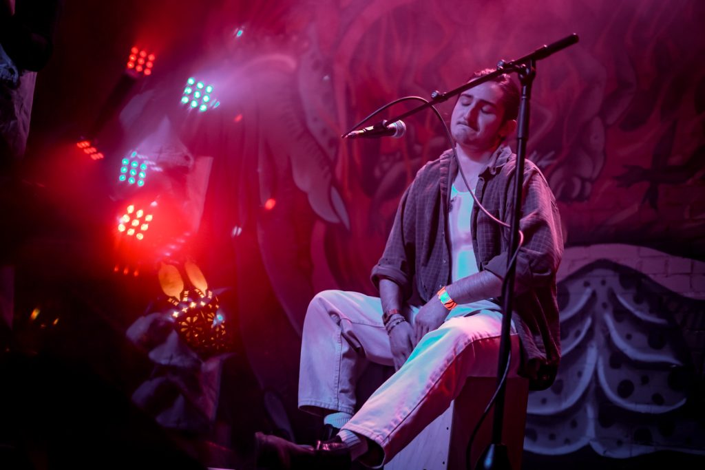 A cajón player on stage