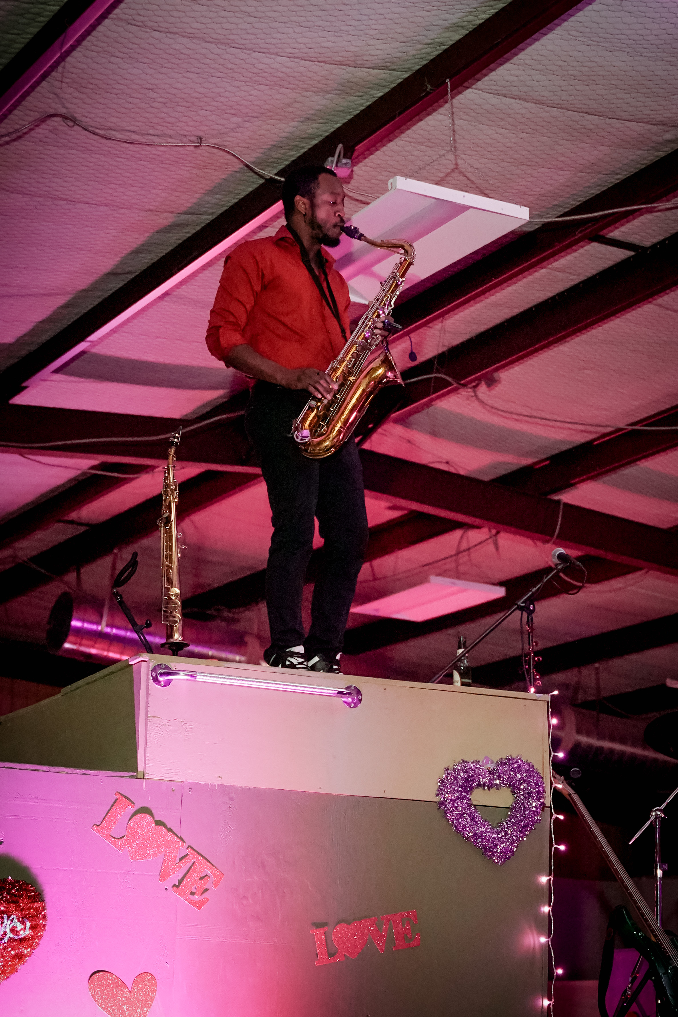 A saxophonist on a platform