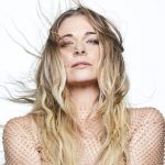 LeAnn Rimes, her hair blowing, stands against a white background