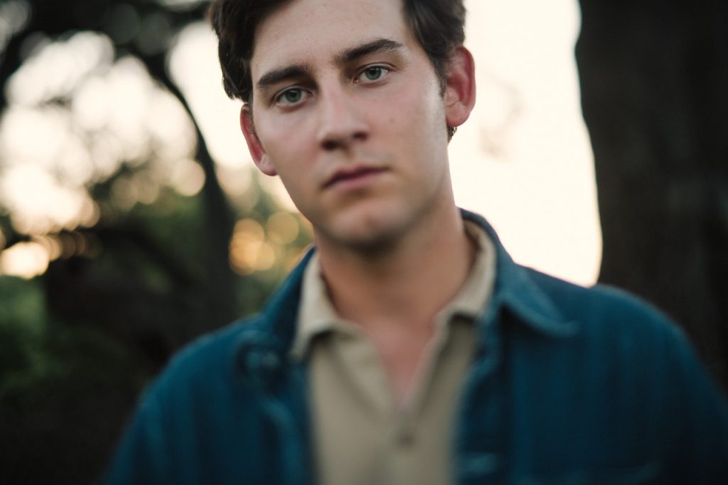 Wearing a denim jacket, Thomas Csorba faces the camera