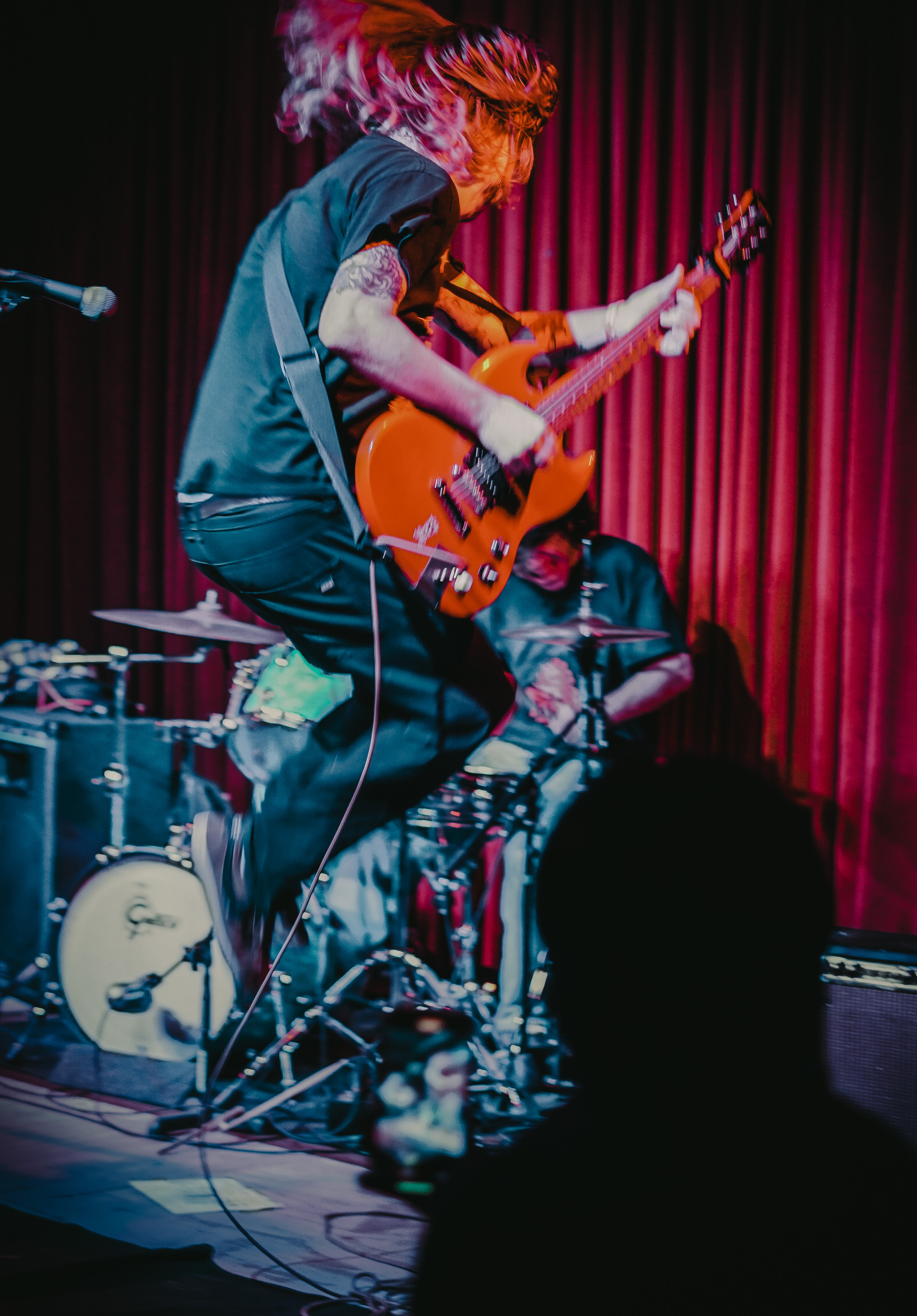 A guitarist jumping in the air