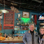 Dan Mojica and Raina Douris stand in front of the bar at Dan's Silverleaf in Denton