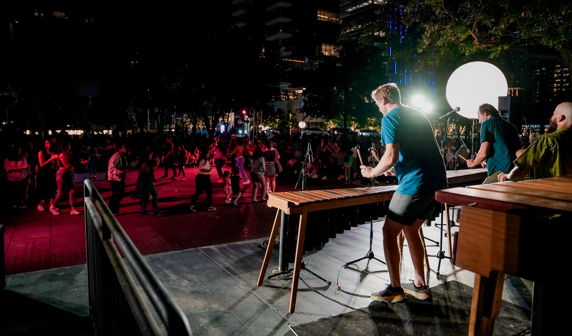People playing marimbas in front of a crowd
