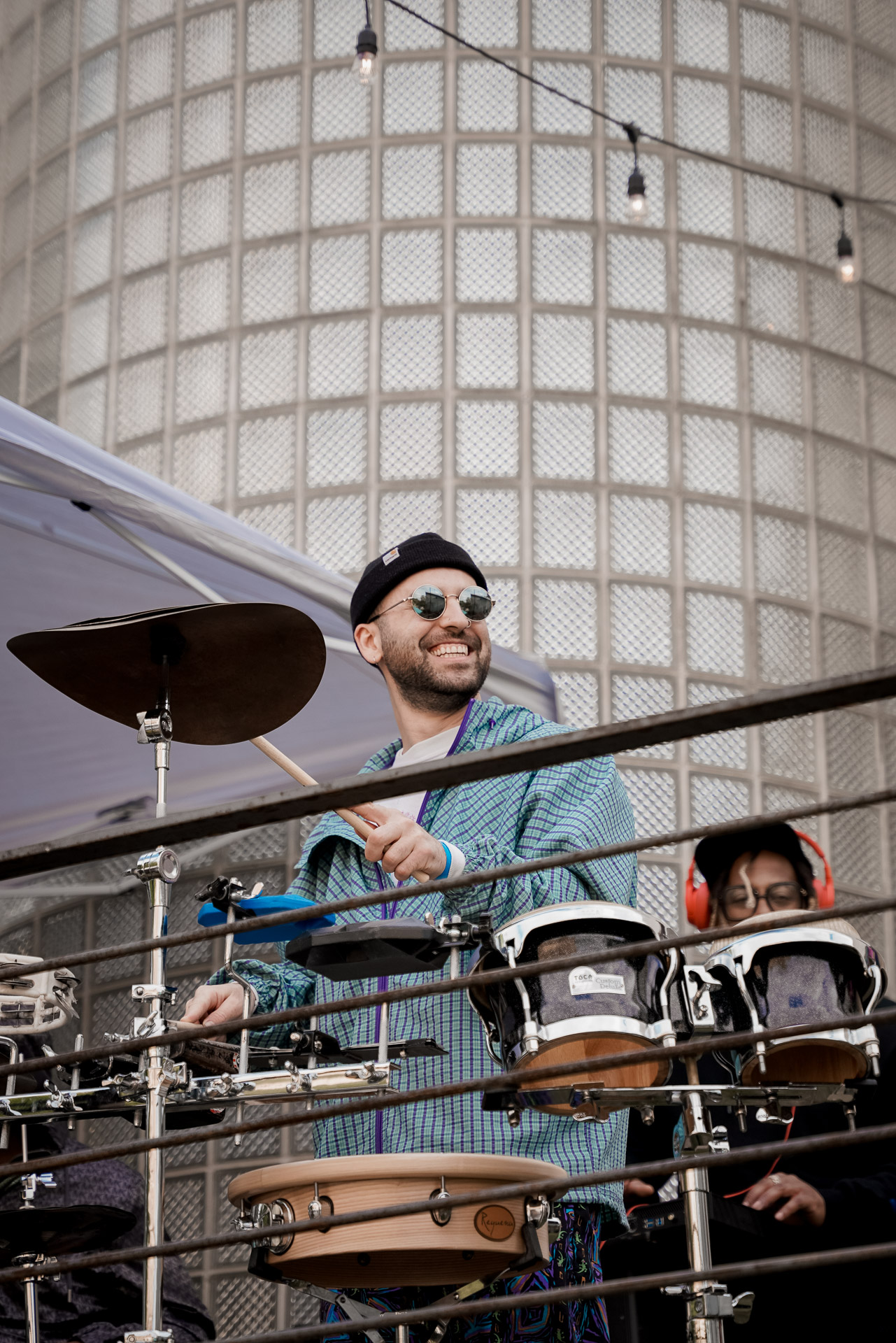 A percussionist playing on stage and smiling