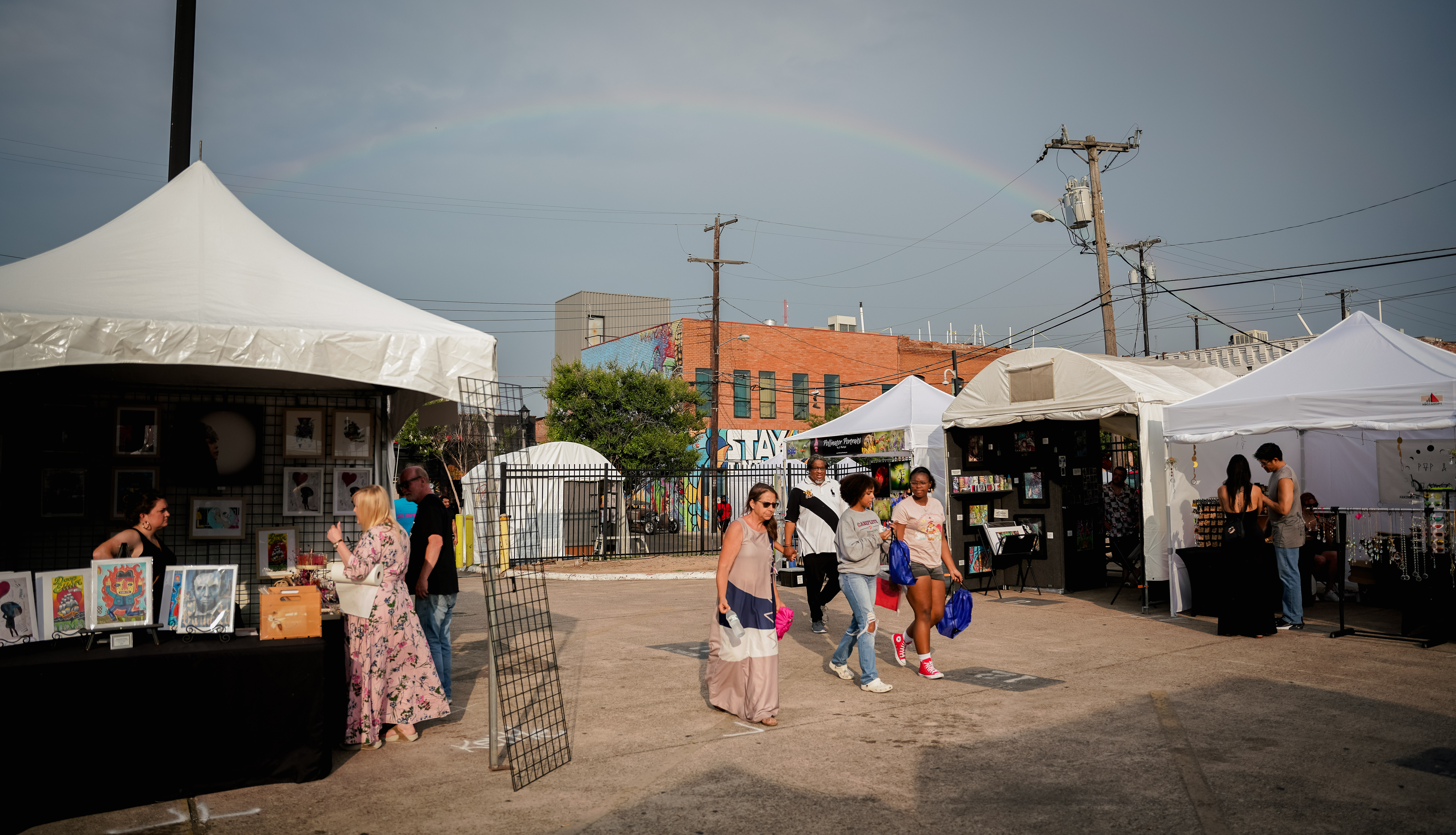 A rainbow over some vendor booths