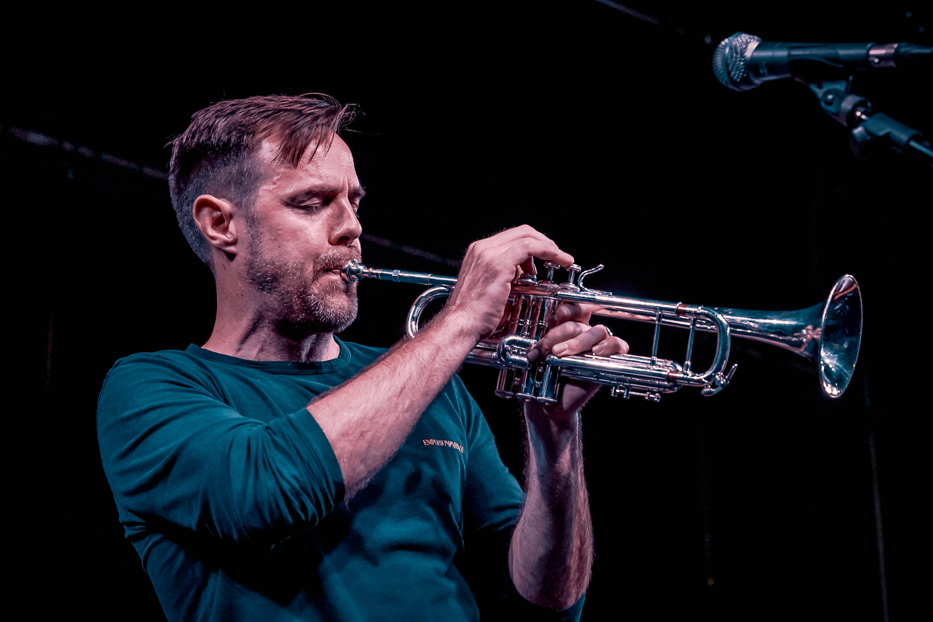 A man playing trumpet on stage