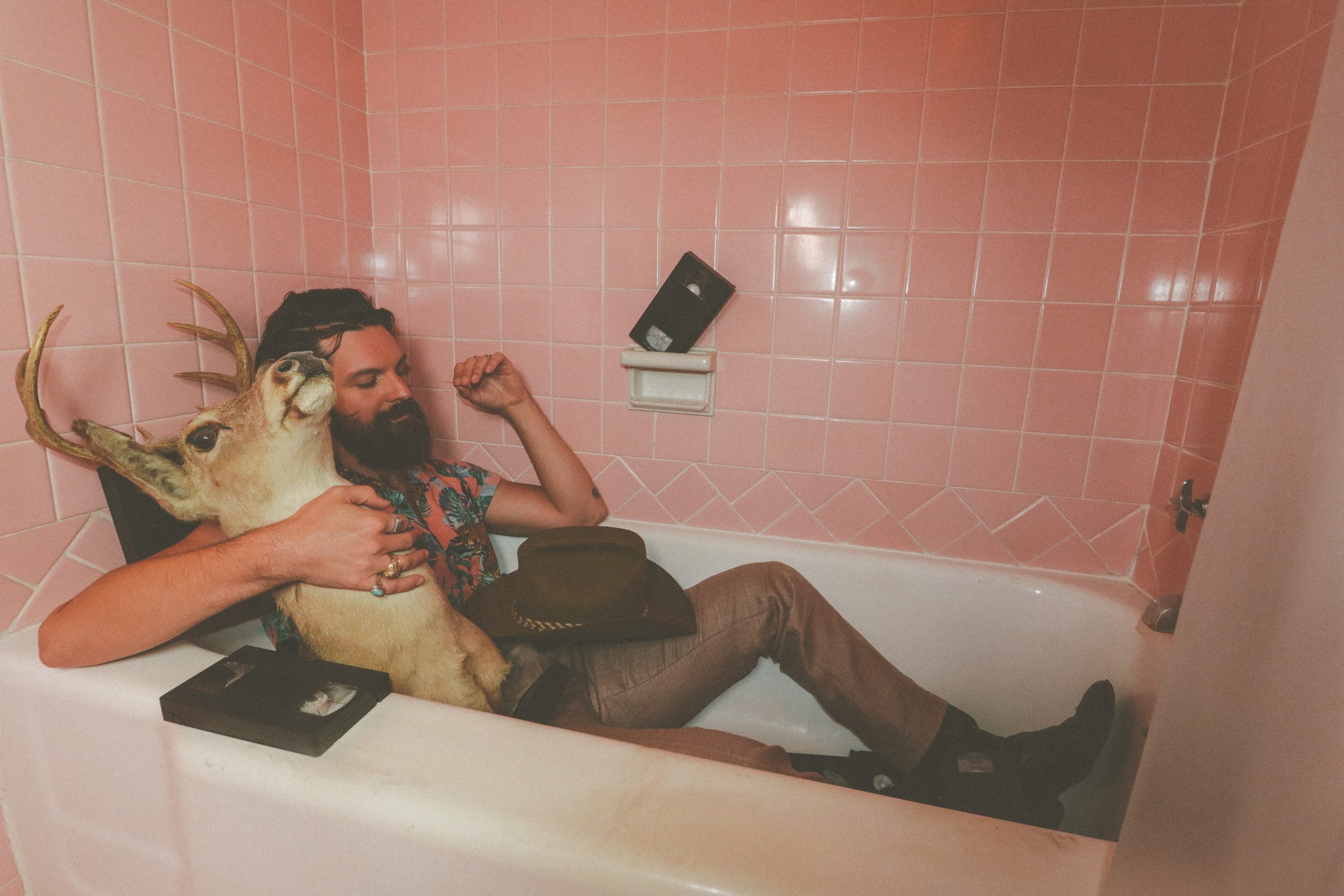 Nathan Mongol Wells reclines in a bathtub