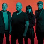 Against a red backdrop, Pixies face the camera