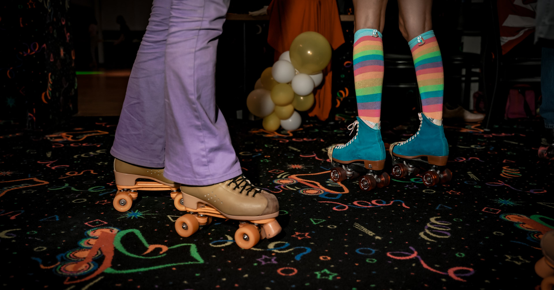 Roller skaters legs with bell bottoms and rainbow socks
